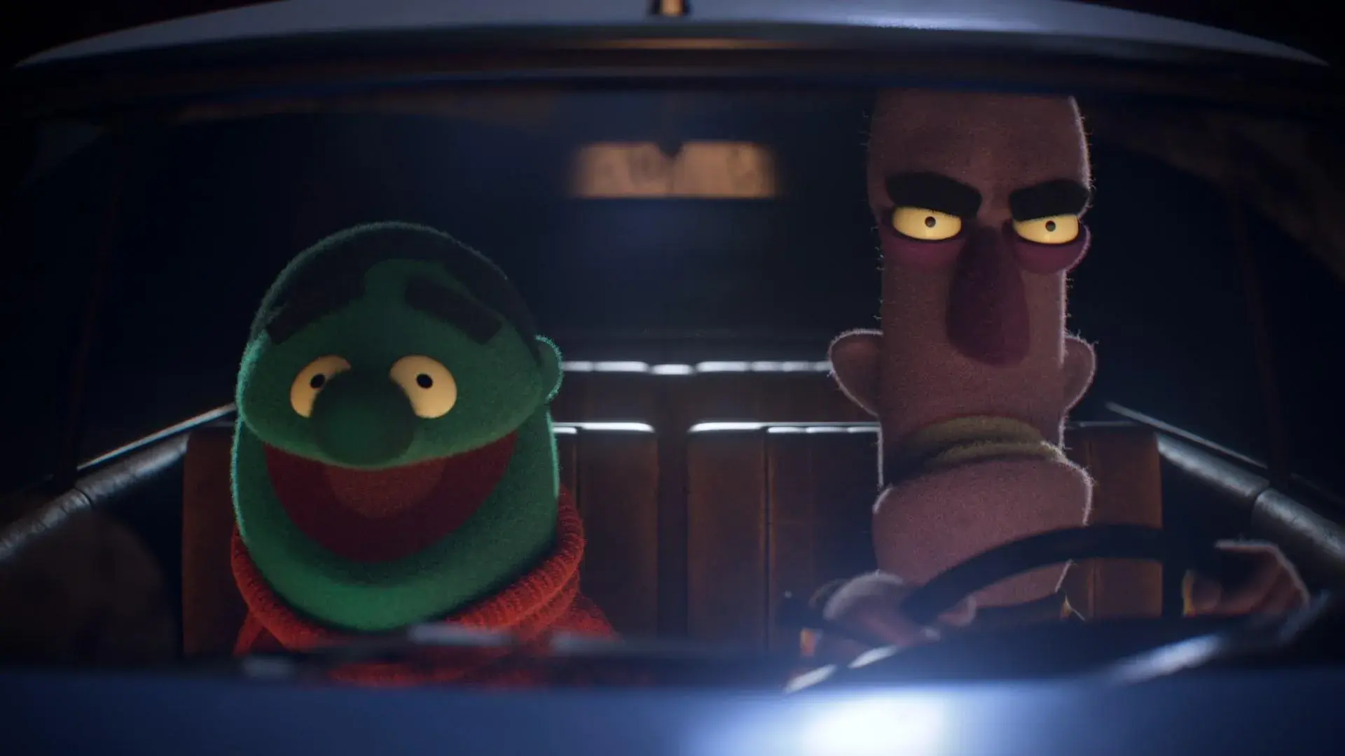 Two animated puppets with distinct expressions sitting in a car at night, created by 23lunes.